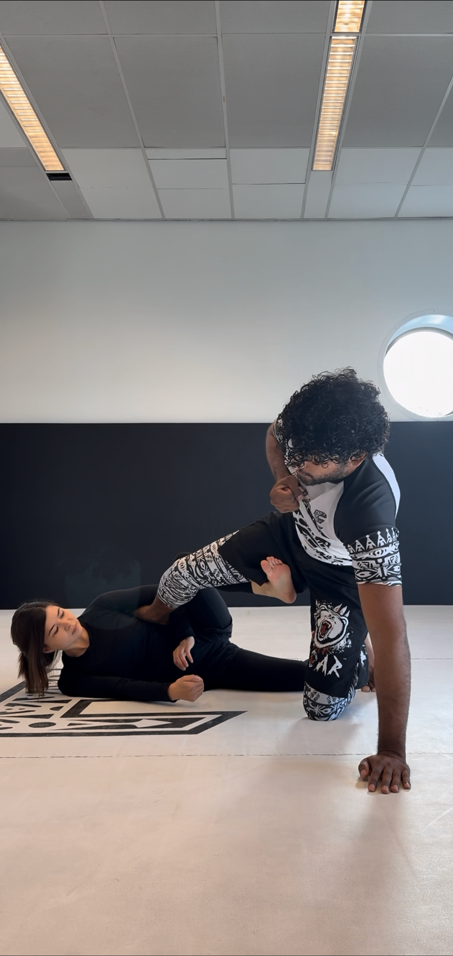 Adelina training Brazilian jiu-jitsu with her coach